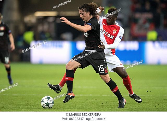 Leverkusen's Julian Baumgartlinger (l) and Monaco's Kevin N'Doram vie for the ball during the Champions League football match between Bayer Leverkusen and AS...