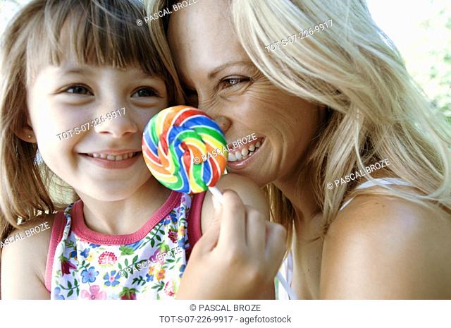 Close-up of a girl and her mother smiling