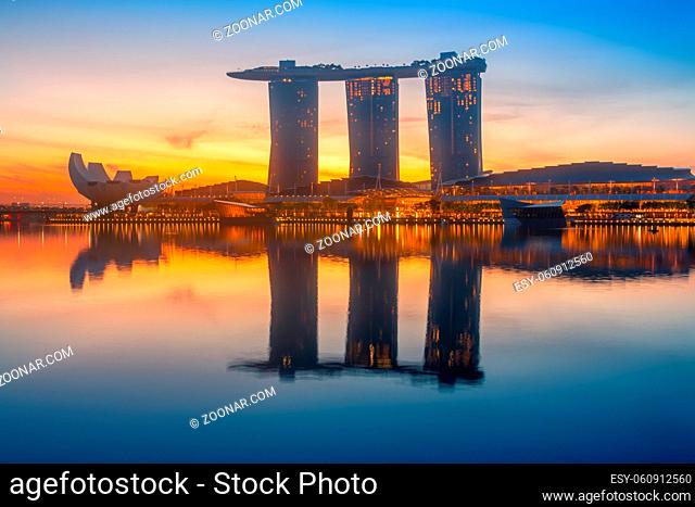 Singapore. Marina Bay Sands Hotel. Colorful sunrise and calm water of the bay