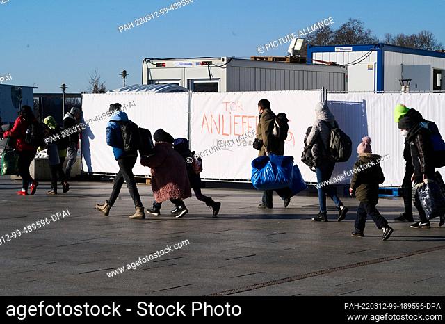 12 March 2022, Berlin: War refugees from Ukraine walk to the tent of the Berlin City Mission at Berlin Central Station, which serves as a first port of call for...