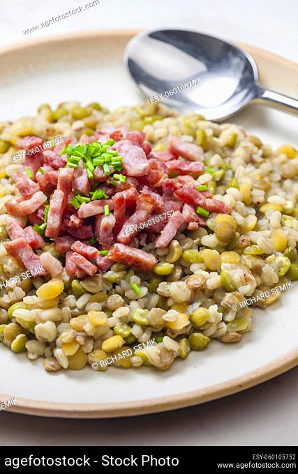 porridge of legumes with fried bacon and chive