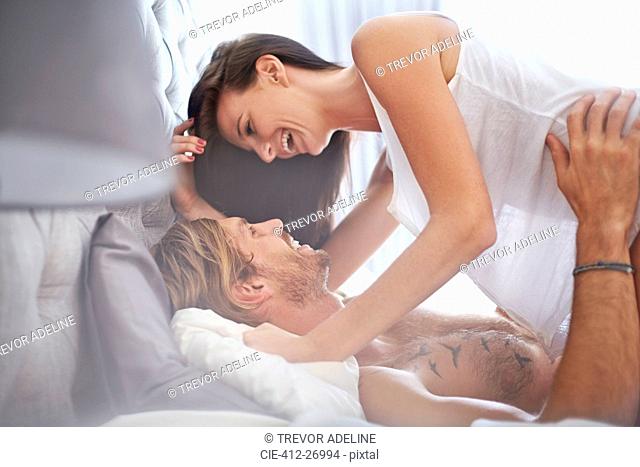 Playful couple on bed