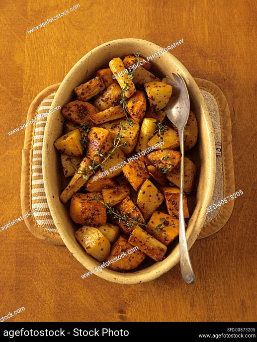 Root vegetables with mustard seeds & thyme in baking dish