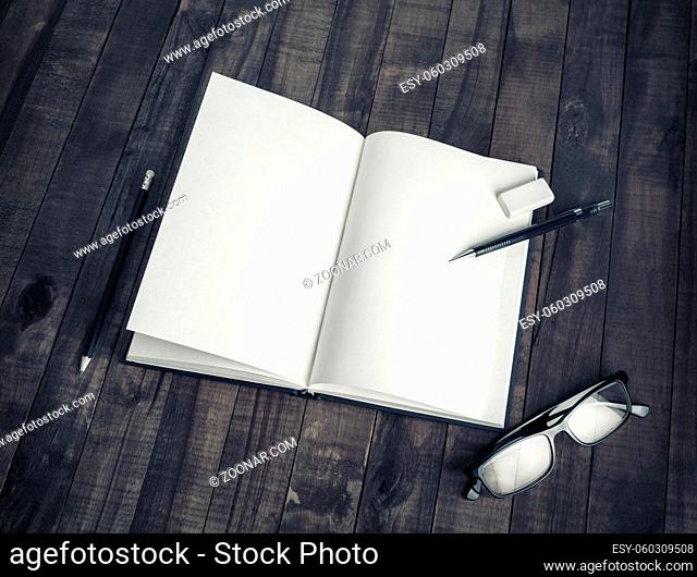 Blank stationery: book, pencil, glasses and eraser on wooden background. Mock up for placing your design