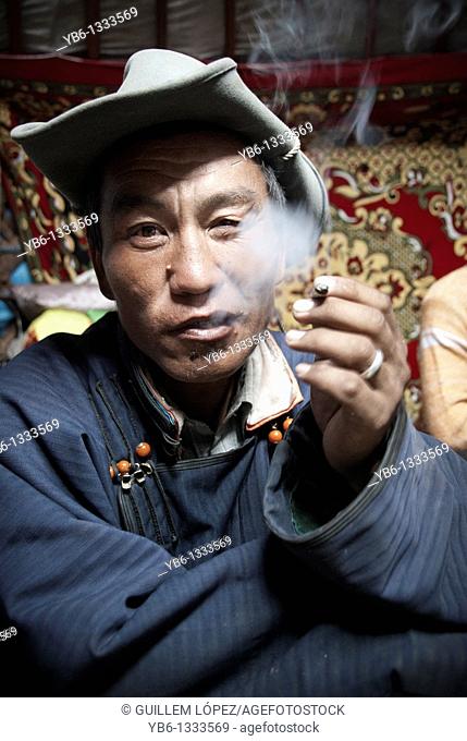 Portrait of a Nomad smoking inside a Ger in Northern Mongolia