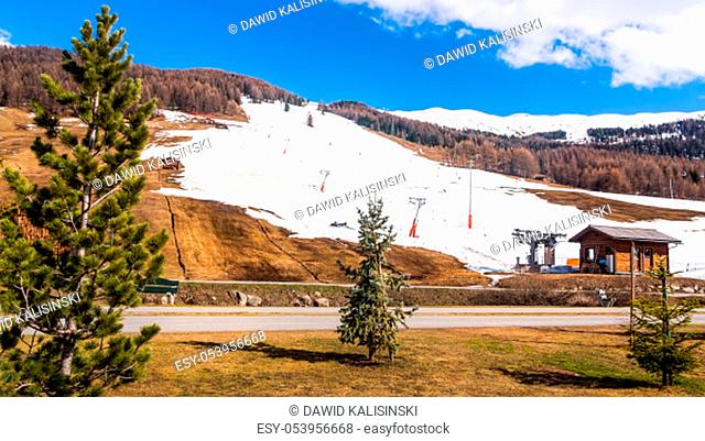 Beautiful mountains in early spring, slopes and pistes with ski lifts, ski and snowboard holidays, Livigno village, Italy, Alps
