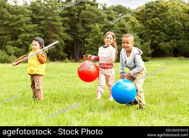 children playing with hoppers and hoop at park