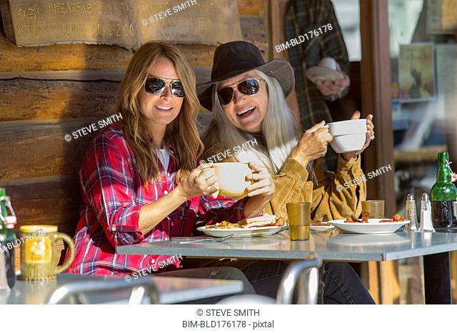 Caucasian women drinking coffee at cafe