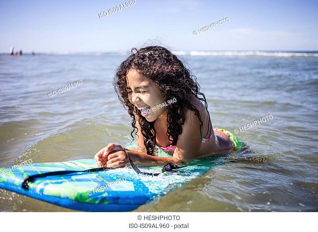 Girl playing on bodyboard, Truro, Massachusetts, Cape Cod, USA