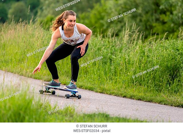 Young woman riding longboard
