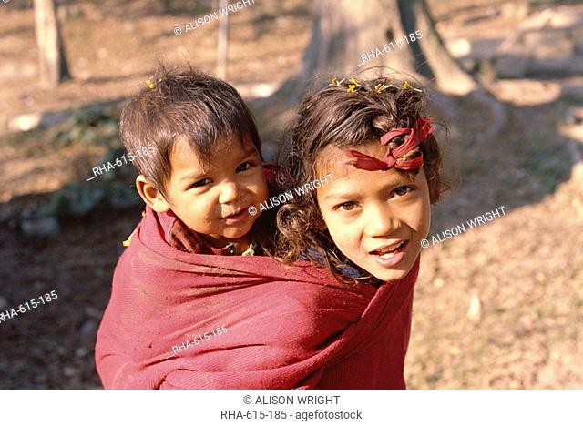 Head and shoulders portrait of two children, Kathmandu, Nepal, Asia
