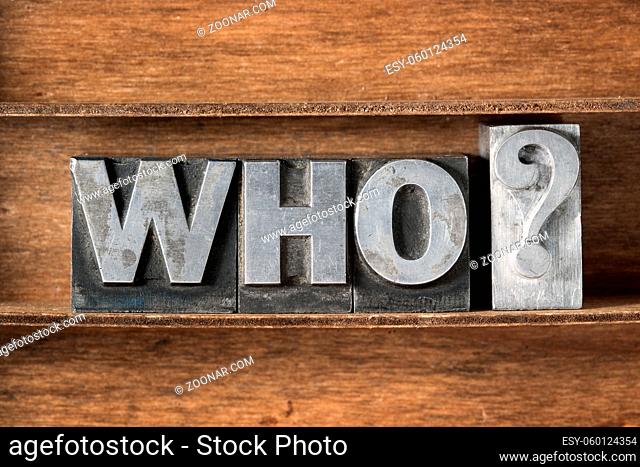 who question phrase made from metallic letterpress type on wooden tray