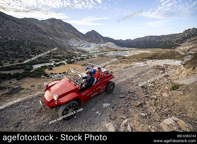 Red beach buggy on sandy track, Alexandros crater behind, caldera of Alexandros and Stefanos crater, Nisyros, Dodecanese, Greece, Europe