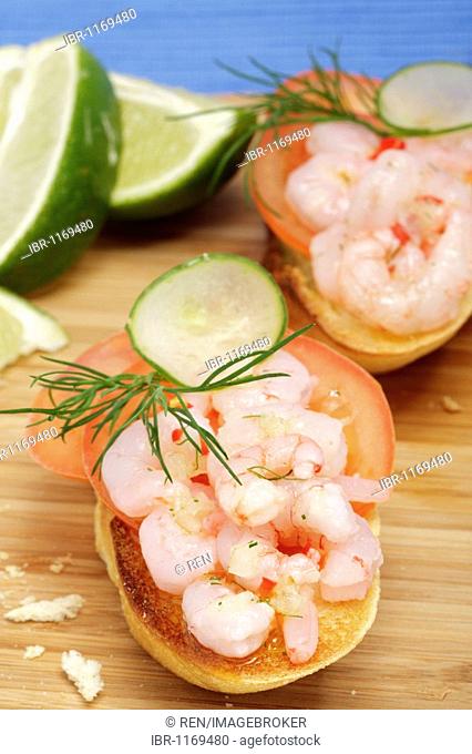Crostini with tomato and brown shrimp salad, lime