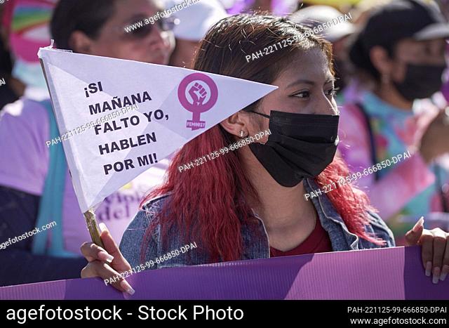 25 November 2022, El Salvador, San Salvador: A woman looks on as she walks in a demonstration marking the International Day for the Elimination of Violence...