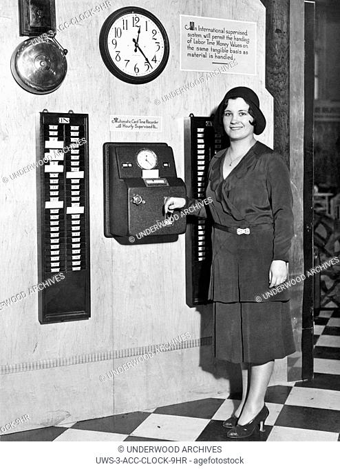 New York, New York: c. 1931.A woman tries out the new Automatic Card Time Recorder at the National Business Show. It is one of the latest ideas in business...