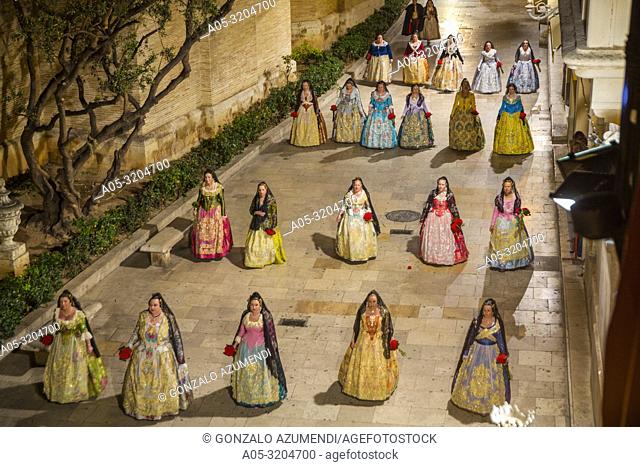 Fallas festival. Falleras. Women in traditional dress. Parade to the Plaza de la Virgin in order to make an offering of flowers to Our Lady of the Forsaken
