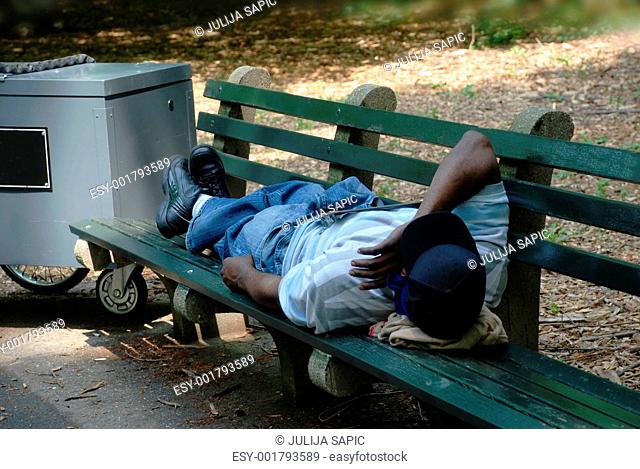 Worker sleeping on park bench