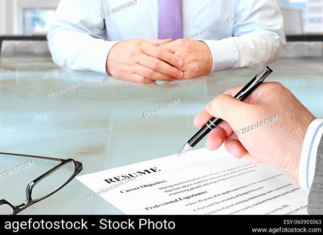 Job Interview in the Office with Focus on Resume and Pen