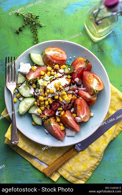 Cucumber and tomato salad with sweetcorn, olives and feta