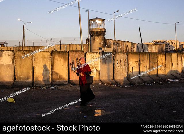 14 April 2023, Palestinian Territories, Qalandia: A Palestinian worshipper passes the Qalandia checkpoint into Jerusalem to attend the fourth Friday prayer of...