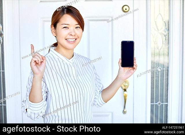 Happy Japanese woman at home