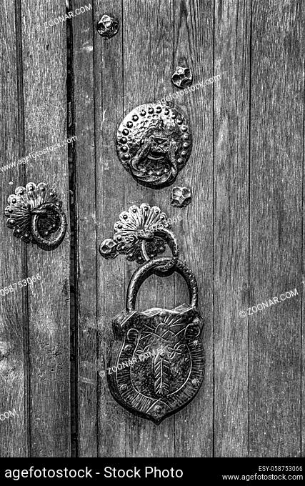Black and white of an old wooden door with a big vintage padlock. True retro style.Close up