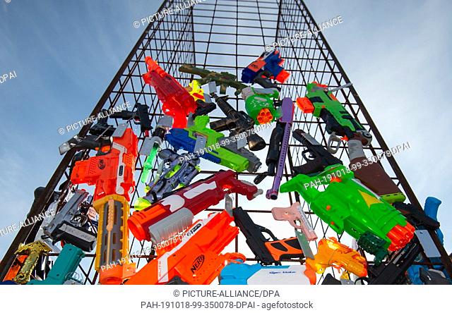 18 October 2019, Bavaria, Nuremberg: A sculpture made of toy weapons, which is currently under construction, is on display in the inner courtyard of the...