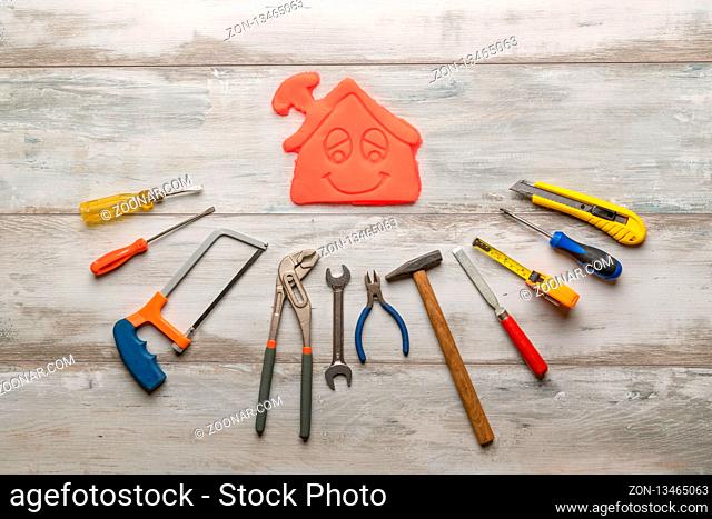 Set of work tool on rustic wooden background with icon of house in space, industry engineer tool concept