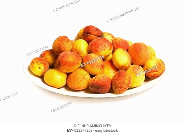 Red apricots in the plate isolated on white