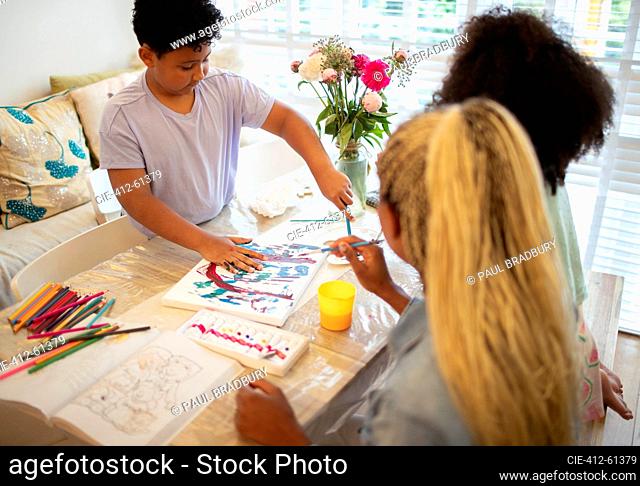 Family painting at table