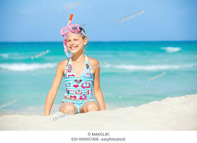 Portrait of a cute girl wearing a mask for diving background of the sea