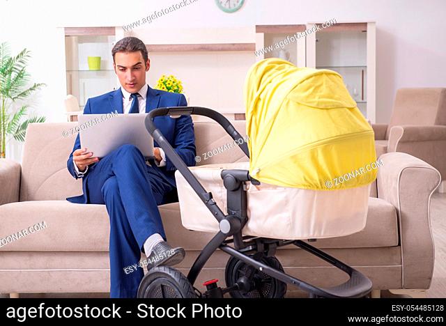 The young businessman looking after baby