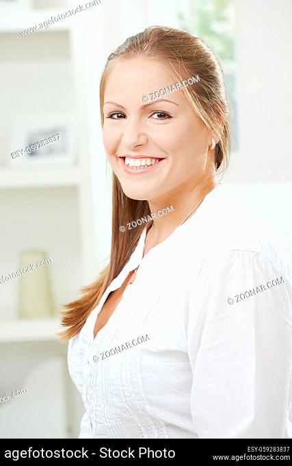 Portrait of happy attractive student girl smiling at home
