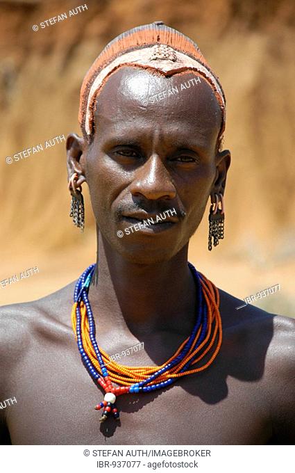 Portrait, man with colourful hairstyle made of clay wearing a necklace, Jinka, Ethiopia, Africa