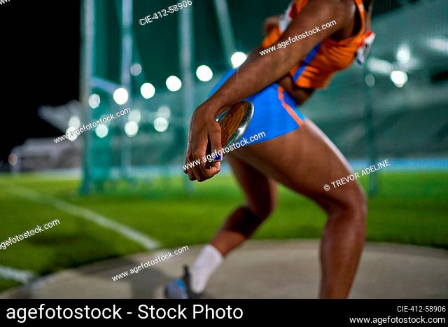 Female track and field athlete throwing discus