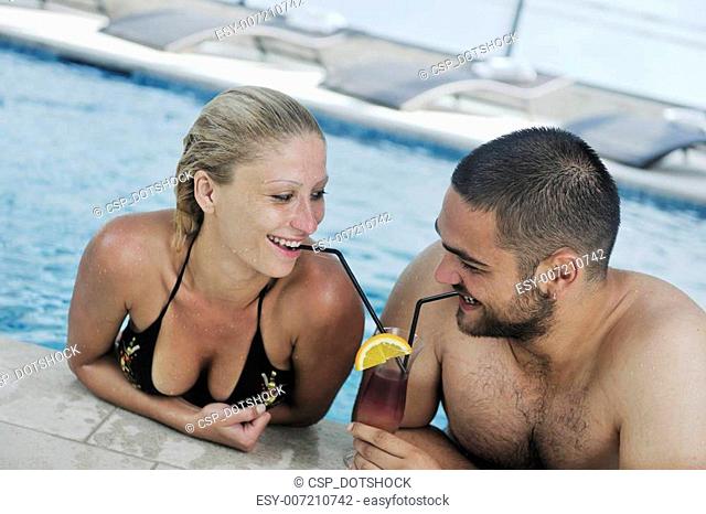 happy cople relaxing at swimming pool