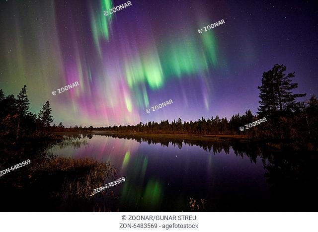 Northern lights reflecting i a lake, Lapland
