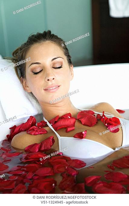 Woman enjoying a bath with petals