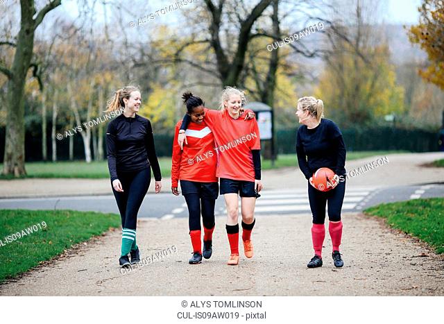 Female soccer players en route to play soccer in park