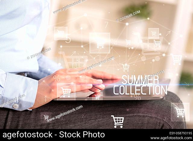Young person makes a purchase through online shopping application with SUMMER COLLECTION inscription