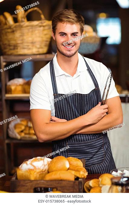 Handsome waiter with arms crossed