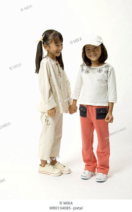 Two elementary age girls holding hands