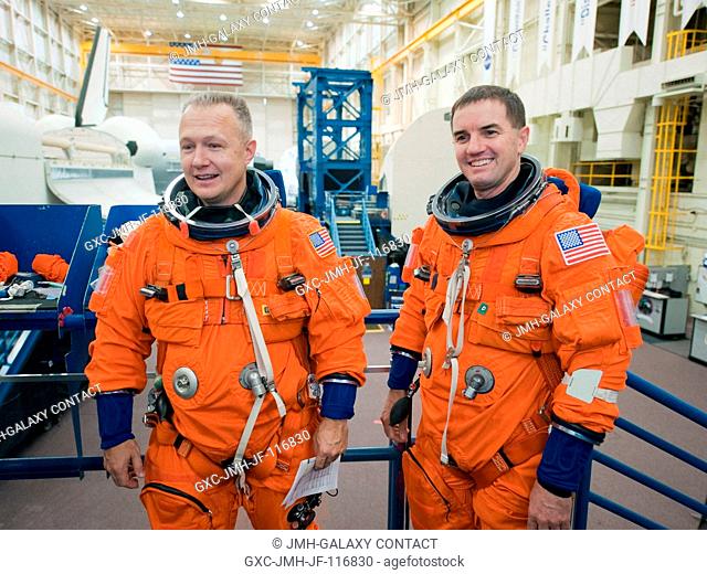 Attired in training versions of their shuttle launch and entry suits, NASA astronauts Doug Hurley (left), STS-135 pilot; and Rex Walheim, mission specialist