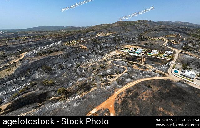 dpatop - 27 July 2023, Greece, Gennadi: Aerial photos from the village of Gennadi show the traces of the fire. But they also show the result of firefighting by...