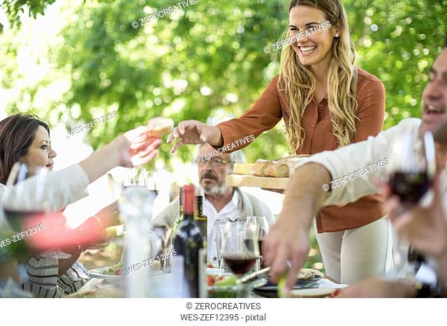 Smiling woman at family lunch in garden