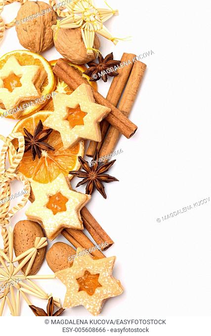 Dry orange slices, spices and Christmas cookies on white background