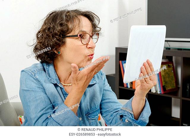 mom making a distant call on internet with her family