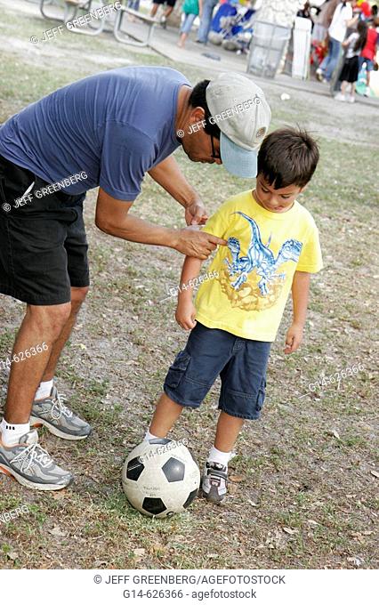 Family Festival of the Arts, disabled activities, Hispanic boy, father soccer ball. Kendall. Miami. Florida. USA