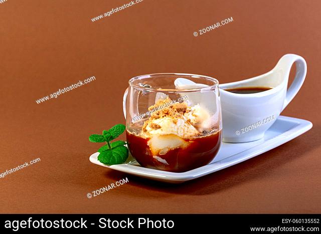Affogato coffee.Traditional Italian dessert of ice cream, espresso and cookie crumb topping is served in a glass cup with a sprig of mint. Copy space